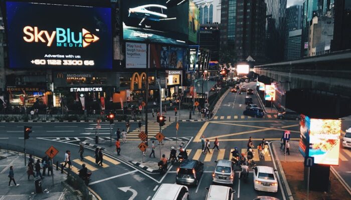 Evening cityscape in Kuala Lumpur with vibrant billboards and bustling traffic. - Photo by KH Tan on Pexels