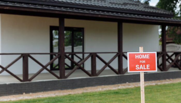 White house with porch and 'Home for Sale' sign on a sunny day. - Photo by Thirdman on Pexels